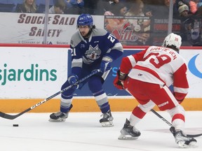 Alex Pharand, left, of the Sudbury Wolves, attempts to skate past Caleb Van De Ven, of the Soo Greyhounds, during OHL action at the Sudbury Community Arena in Sudbury, Ont. on Wednesday March 15, 2023