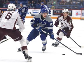 David Goyette, middle, of the Sudbury Wolves, breaks between Konnor Smith, left, and Quinton Page, of the Peterborough Petes, during OHL action at the Sudbury Community Arena in Sudbury, Ont. on Friday March 17, 2023. John Lappa/Sudbury Star/Postmedia Network