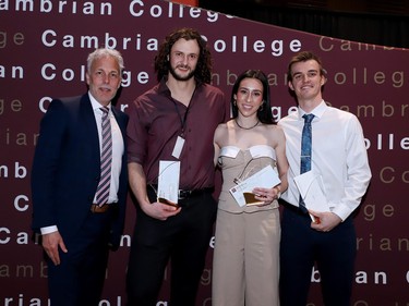 Cambrian College interim president Shawn Poland presents athlete of the year awards to Sven Trodel, Isabelle Rivest and Jack Daley at Cambrian Colleges 55th annual athletic awards banquet on Tuesday night. Gino Donato/For The Sudbury Star.