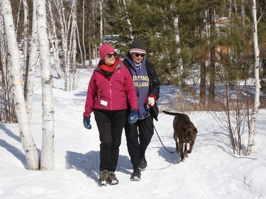 Heather Jeramaz, left, Nada Jeramaz and Shae the dog go for a walk on one of the trails at Kivi Park in Sudbury, Ont. on Thursday March 30, 2023. John Lappa/Sudbury Star/Postmedia Network