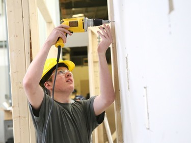 Grade 10 student Tim Wagler, 15, of Ecole secondaire catholique La Renaissance in Espanola, learns to install drywall at the Carpenters union local 2486 facility in Azilda, Ont. on Friday March 31, 2023. Grade 9 and 10 students from Renaissance where at the Carpenters union learning about construction trades through the Ontario Youth Apprenticeship Program (OYAP). John Lappa/Sudbury Star/Postmedia Network