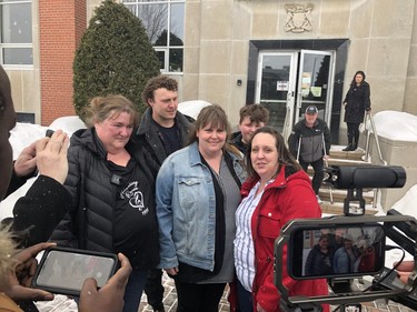 Kim Sweeney, centre, is approached by media outside the Sudbury courthouse on Wednesday after a jury found Robert Steven Wright guilty of her sister Renee's murder. She is flanked by supporters. PHOTO BY HAROLD CARMICHAEL/SUDBURY STAR