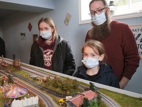 Isaiah, Hayden and Nathan Bertrand of Simcoe examine a track layout in Delhi Saturday during the Brant-Haldimand-Norfolk Model Railroad Layout Tour.  CHRIS ABBOTT