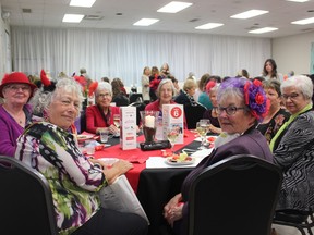 A group of longtime Gems & Java guests, members of a Red Hat Society who dress in style every year, enjoy the 2022 event at the South Gate Centre. (Submitted)