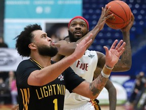Dexter Williams Jr., right, of the Sudbury Five drives to the basket against Jermaine Haley Jr. of the London Lightning, in a National Basketball League of Canada game at the Sudbury Community Arena on Thursday, March 17, 2022. (John Lappa/Postmedia Network)