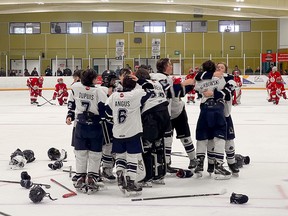 Players from the Nickel City Junior Sons U13 AAA team celebrate their championship win over the Soo Junior Greyhounds.