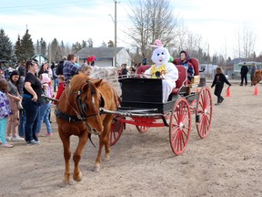 Whitecourt kids including Seamus, right, (accompanied by Lachlan Penton on his left) took the opportunity to hitch a wagon ride with the Easter Bunny as the driver during the Community Easter Party Saturday. The event was hosted at Blue Ridge Community Hall.