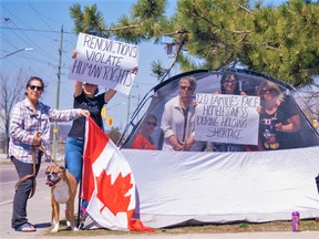 Tenants of an apartment block facing an uncertain future protested for a second day Thursday after Bedford Properties served them 'renoviction' notices notifying them their leases would end July 31 to make way for renovations. DAVID LECLAIR