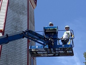 Heritage Restoration Inc. masons Rob Lee, left, and Fred Lee work on the Port Burwell lighthouse on Friday, April 14, 2023. The company is shoring up the 183-year-old structure that was closed in January because of the possibility it could be toppled by strong winds. (Heather Rivers/The London Free Press)