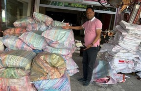 Multicultural Association of Perth Huron executive director Geza Wordofa stands next to a pile of supplies donated by Stratford-area residents and shipped to Turkey by the association to aid with earthquake-relief efforts in that country.  Submitted photo