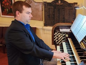 Devon Hansen, music director at St. Andrew's United Church in Chatham, warms up for a noon-time recital on Monday as part of Organ Week. The church is celebrating the 100th anniversary of its Casavant pipe organ. (Trevor Terfloth/The Daily News)