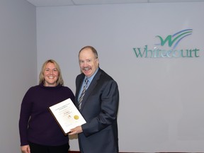 Chelsea Grande, town community services director, left, received a plaque presented by Mayor Tom Pickard during the council meeting Tuesday. The plaque is from the Canadian Accreditation Council of Human Services, which audited Whitecourt for its Family and Community Support Services programs, Pickard said. The plaque states Whitecourt met standards.