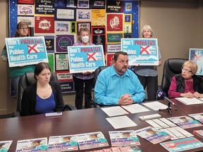 (Front from left) Jen McCarthy, Henri Giroux, and Karina Tulisalo present the North Bay Health Coalition’s concerns about Bill 60. Standing in solidarity behind them from the left is Louise Walker, a retired nurse, Sue McIntyre a working nurse, and concerned citizen Betty Hotchkin.