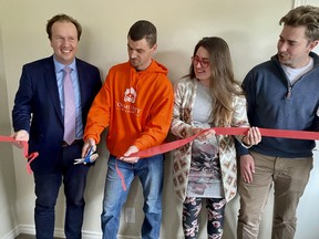 Mayor Paul Lefebbvre (left), cuts the ribbon to open the first Reside home on Kingslea Court, along with Josh, a Community Builders participant who helped renovate five homes in Sudbury; Carly Gasparini, managing director of Community Builders; and Adrian Dingle of Raising the Roof.