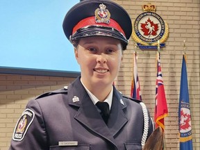 const.  Destinee Dagenais, one of nine new Chatham-Kent police officers sworn in Friday, is shown in council chambers with the eagle feather on which she took her oath, a first for the service.  (Trevor Terfloth/The Daily News)