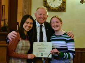 Stratford District secondary school Eco Club co-chairs Lucy Chung (left) and Sammie Orr (right) receive a Stratford Green Recognition certificate from Mayor Martin Ritsma at Monday's Stratford council meeting. Galen Simmons/The Beacon Herald/Postmedia Network