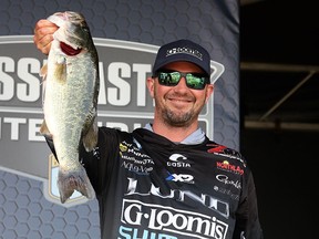 Jeff Gustafson holds up a six pound largemouth bass from day two of the Bassmaster Elite tournament at Lake Murray last week. He is back in action this week at Santee Cooper Reservoir.