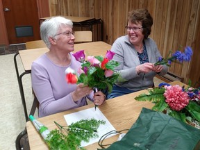 Barb Helm and Suzanne Blake share a laugh while working on their flower arrangements during the April 18 meeting of the Lucknow Horticultural Society. Submitted photo.