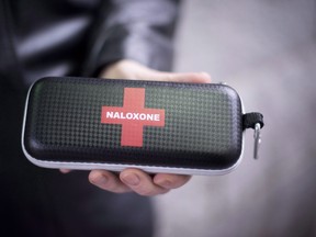 A naloxone anti-overdose kit is held in downtown Vancouver, B.C., Friday, Feb. 10, 2017. British Columbia Emergency Health Services has released grim statistics on the toxic drug crisis ahead of the seventh anniversary of the province declaring a public health emergency.