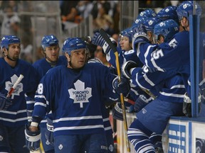 Right wing Tie Domi #28 of the Toronto Maple Leafs celebrates with his teammates during game seven of the eastern conference quarterfinals against the Ottawa Senators at Air Canada Centre on April 20, 2004 in Toronto. The Leafs defeated the Senators 4-1 to win the series 4-3. (Photo By Dave Sandford/Getty Images)