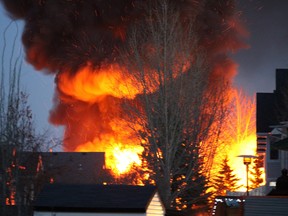 A fire that destroyed a backyard shed and damaged nearby homes  is seen from the backyard of a home on Warren Road on Friday, April 28, 2023. The home where the fire started was at the corner of Wilson Drive and Williams Drive. Vincent McDermott/Fort McMurray Today/Postmedia Network