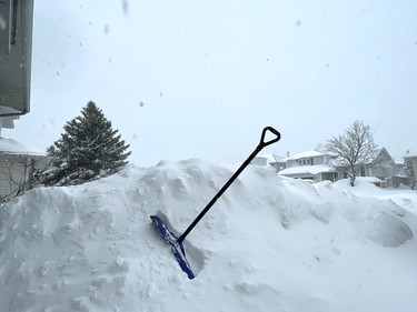 A shovel, soon to be put to use, sticks out of a snowbank in the community of Garson in Greater Sudbury, Ontario while more snow keeps falling on Saturday, April 1, 2023. The City of Greater Sudbury declared a Significant Weather Event on Saturday morning due to the ongoing storm. Ben Leeson/The Sudbury Star/Postmedia Network