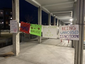 Encampment plan protest signs outside Prince George city hall
