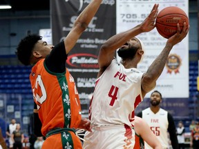 Dexter Williams Jr. (4) of the Sudbury Five goes up for a layup against Tyrell Gumbs-Frater (10) of l'Academie d'Alma during NBLC action at Sudbury Community Arena in Sudbury, Ontario on Saturday, April 15, 2023.