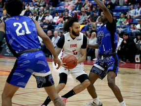 Sudbury Five forward Jeremy Harris (5) drives between a couple of Jamestown Jackals players during a NBLC action at Sudbury Community Arena in Sudbury, Ontario on Saturday, April 22, 2023.