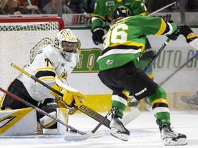 London Knights' Denver Barkey tries to lift the puck over the pad of Sarnia Sting goalie Ben Gaudreau early in Game 2 of the OHL Western Conference final at Budweiser Gardens in London, Ont., on Sunday, April 30, 2023. 
Mike Hensen/The London Free Press/Postmedia Network