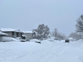 Snow blankets a neighbourhood in the community of Garson in Greater Sudbury, Ontario while more keeps falling on Saturday, April 1, 2023. The City of Greater Sudbury declared a Significant Weather Event on Saturday morning due to the ongoing storm.