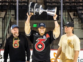 Burford's Emma Woods, with dad, Robert, and brother, Hayden, holds up the Isobel Cup after her team, the Toronto Six, defeated the Minnesota Whitecaps 4-3 in the recent Premier Hockey Federation championship game. Submitted