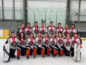The Zone 2 U19 ringette team takes a group photo wearing their silver medals earned at the Canadian Ringette Championships.
