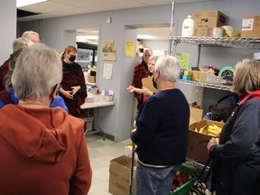 Members of the Probus Club of Belleville listen to Food Bank director Suzanne Quinlan (holding large brown folder) as she tells them all about Belleville's Gleaners Food Bank. A large number of the club's members attended the tour Thursday afternoon. JACK EVANS PHOTO