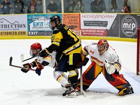 Trdenton Golden Hawks Ryan Holmes (#16) battles for position  with Wellington Dukes Julien Jacob (#22) in front of Dukes goalie Jacob Osborne during the Golden Hawks dramatic series-cliniching 2-1 double overtime win Friday at the Wellington and District Community Centre. ED MCPHERSON/OJHL IMAGES