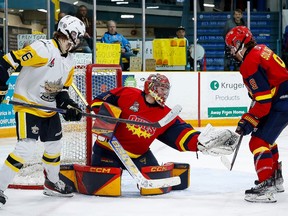 Wellington Dukes Jacob Osborne (#1) makes the save with Trenton Golden Hawks Ryan Holmes looking for a rebond during the Dukes 4-1 win Saturday at ther Community Gardens. AMY DEROCHE/OJHL IMAGES
