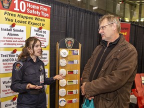 Teagan Knowles, fire safety educator at the Brantford Fire Department talks with Mike Bialas on Friday  at the 53rd annual Brantford Lifestyle Spring Home Show at the Civic Centre in Brantford. The show continues Saturday and Sunday from 11 a.m. to 5 p.m. and a free family pass is available by visiting brantfordhomeshow.com