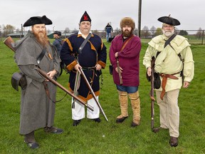 Re-enactors (from left) Jason Jones, Jim Thompson, Reed Braund, and James Braund fired their muskets to signal the start of the Paris to Ancaster 110-km Cento bike race in Paris, Ontario.  They are members of the McEwan's Living History Association.