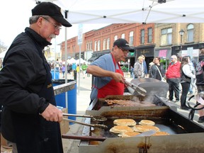 Paris Lions Club members Dave Shewfelt (left) and Scott Robinson cooked for hours on Saturday, April 8, 2023 at the Paris Lions' Maple Syrup Festival. MICHELLE RUBY/Brantford Expositor
