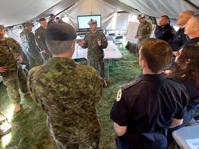 Lt.-Col.  Shawn Dumbreck, Commanding Officer with the 31 Territorial Brigade Group, provides a briefing on Exercise Arrowhead Response, on Saturday morning from the headquarters of the operation that was set up on the grounds of the Col.  EM Ansell Armory in Chatham.  PHOTOEllwood Shreve/Postmedia