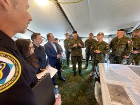 Mayor Darrin Canniff, fourth from left, listens as Col.  Chris Brown, fifth from left, outlines some of the objectives of Exercise Arrowhead Response on Saturday morning.  PHOTOEllwood Shreve/Postmedia
