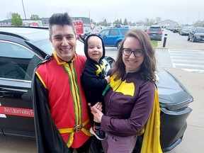 Chatham's Edmondstone family, including dad Colin, mom Alie and son Rowan, 18 months, represent Batman and Robin at the ninth Chatham-Kent Expo at Bradley Convention Centre in Chatham Saturday. (ELLWOOD SHREVE/The Chatham Daily News)