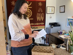 Stockbridge-Munsee Tribe's tribal historic preservation manager Bonnie Hartley reads text that was provided with a traditional Mohican basket returned to the community in April 2023, in Stockbridge-Munsee Band Mohican Nation. M. Eleanor McGrath/Special to the Cornwall Standard-Freeholder/Postmedia Network