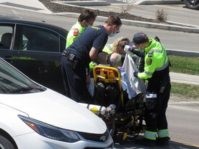 Frontenac Paramedics tend to an elderly patient involved in a two-car collision on Gardiners Road in Kingston, Ont. on Friday, April 14, 2023.