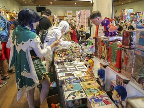 Costume-clad visitors shop the market at Kingston ComiCon at the Royal Canadian Legion Branch 560 in Kingston on Sunday, April 16, 2023.