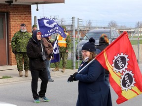 Members of the Public Service Alliance of Canada walk the picket line at the main gate of Canadian Forces Base Kingston on Wednesday, April 19, 2023.