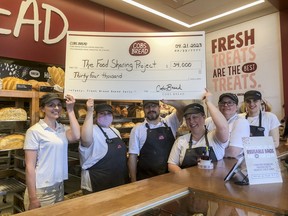 COBS Bread Kingston owner Ashley Logan, left, with her staff on Friday, April 21, 2203, with the cheque showing they raised $33,947 during COBS Bread's annual Doughnation Day campaign.