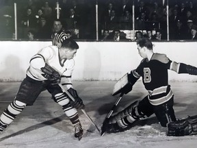Barrie Flyers goaltender Bob Senior stymies Toronto Marlboros forward Bob Pulford with a nifty skate save in a 1955-56 Ontario Hockey Association junior game.