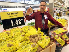 Curtis Scott, assistant store manager at the Real Canadian Superstore on Dougall Avenue in Windsor, Ont., displays a potato from the Naturally Imperfect line, on March 12, 2015.
(DAN JANISSE/ The Windsor Star)