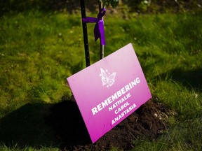 People take part in a vigil at the Women's Monument in Petawawa, Ont., following the jury's release of recommendations in the inquest in Pembroke, Ont., Tuesday, June 28, 2022. Experts say a coroner's inquest has highlighted the need for a co-ordinated approach to intimate partner violence, including ways to address perpetrators as well as oversight and accountability measures to ensure that real change is being made.